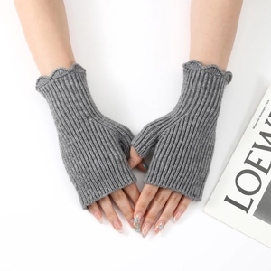 Detail of grey knitted fingerless gloves with ruffled edges and vertical ribbed texture