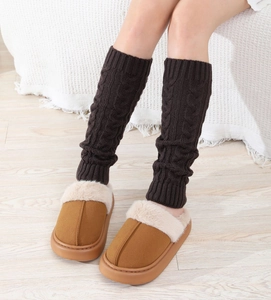 Detail of chunky cable-knit leg warmers and cozy faux suede plush slippers set