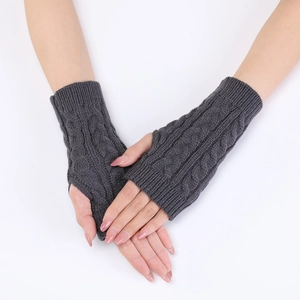 Detail of dark grey cable knit arm warmers with thumb hole and textured fingerless design