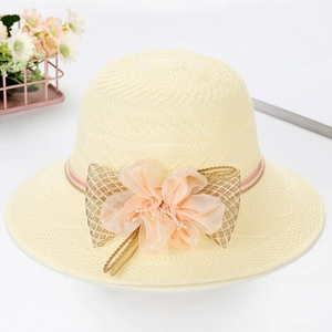 Detail of summer straw hat featuring organza flower, mesh bow, and faux pearls decoration