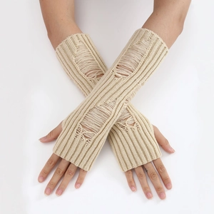 Close-up of beige distressed knit arm warmers with thumb holes and ripped texture