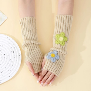 Detailed knit texture and floral embroidery on cream fingerless Y2K arm warmers