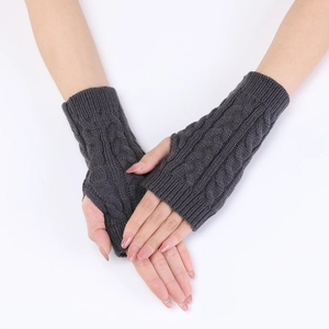Close-up of dark grey cable knit arm warmers showing texture and ribbed cuffs
