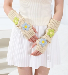 Close-up of knit arm warmers with 3D floral details and ribbing for women