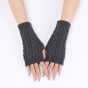 Detail of dark grey cable knit arm warmers with fingerless design and ribbed texture