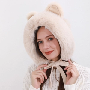 Close-up of beige plush trapper hat with cute animal ears and soft faux fur texture