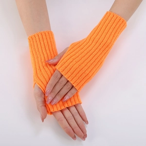 Detail of orange ribbed knit fingerless gloves showing elastic texture and soft fabric
