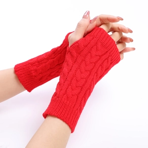 Detailed cable knit pattern on warm red fingerless arm warmers for autumn and winter