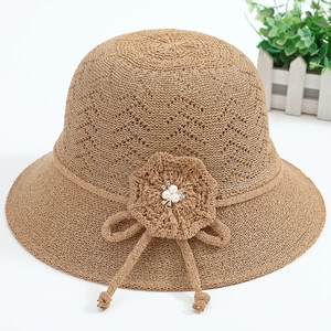 Detail of crochet sun hat with hollow diamond pattern and pearl floral decoration