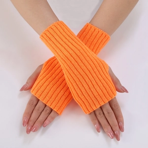 Close-up of bright orange ribbed knit fingerless gloves with thick vertical texture