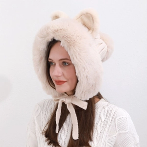 Close-up of cream plush fox ear hat with soft fur texture and side strap details