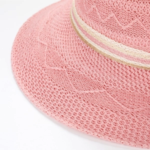 Close-up of pink woven sun hat with detailed crochet texture and glitter striped band
