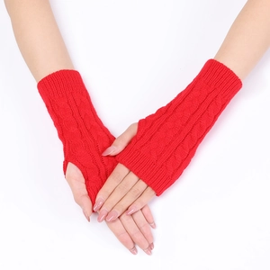 Detailed knit cable pattern on red fingerless arm warmers for autumn and winter