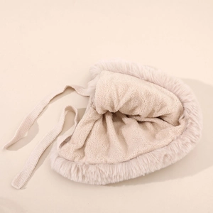 Detail of warm off-white plush trapper hat with fluffy faux fur trim and cozy fleece lining