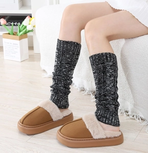 Detailed knit texture of cable-knit leg warmers paired with plush faux fur slippers