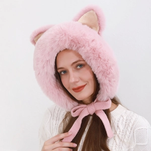 Close-up of pink plush hat featuring cute faux fur ears and knit tassels detail