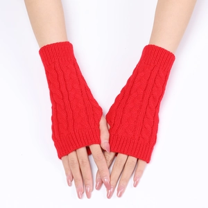 Detailed cable knit pattern on red fingerless gloves with thumb hole for winter
