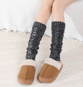 Detailed knit texture of cable pattern leg warmers paired with plush winter slippers