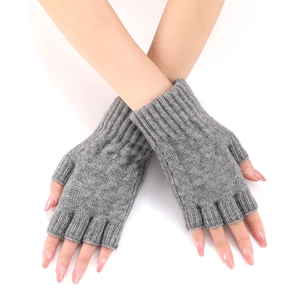 Detailed knit texture of gray fingerless arm warmers with ribbed cuffs and thumb hole