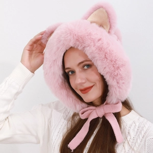 Detail of pink plush hat with animal ears and knitted ribbons showing soft texture