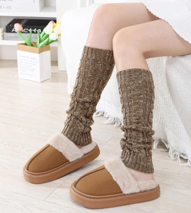Detailed cable knit pattern on warm thick leg warmers and cozy winter plush slippers