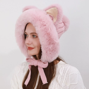 Detail of pink faux fur cat ear hat with soft plush texture and knitted ties