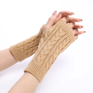 Detail of cable knit camel arm warmers with thumb holes in soft winter texture