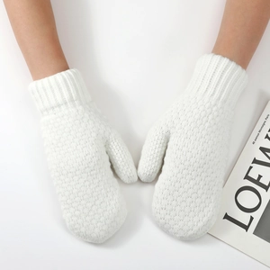 Detail of white chunky knit mittens with ribbed cuffs and soft thermal wool texture