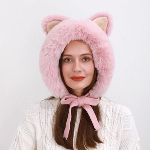 Close-up of pink faux fur cat ear hat with knitted ties and soft plush texture for winter