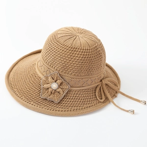 Close-up of khaki knitted sun hat featuring delicate hollow mesh and floral pearl detail