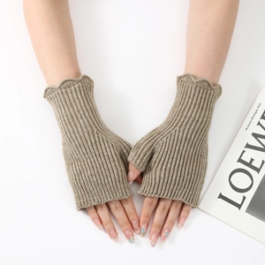 Detail view of khaki knit fingerless gloves with ribbed texture and ruffled wave cuffs