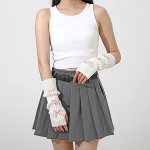 Detail showing white ribbed knit arm warmers with cute pink bows and fingerless design