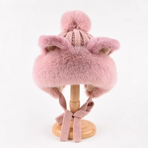 Detailed texture of pink plush cat ear hat with warm knit fabric and soft faux fur lining