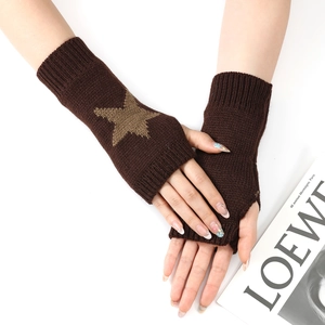 Détail du tricot des mitaines marron foncé ornées d'un motif d'étoile café au lait