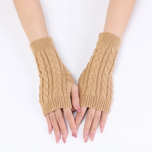 Detail of camel cable knit fingerless gloves showing elastic texture and warm wool fabric