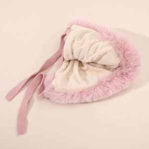 Detail view of pink plush winter hat with warm beige fleece lining and knit straps