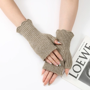 Detailed macro of khaki ribbed knit fingerless gloves with elegant ruffle trim edges