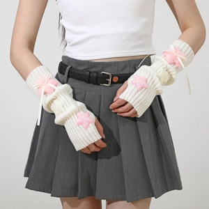 Detail of white knit arm warmer with plush pink star and ribbon bow in Y2K style