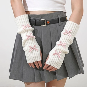 Close-up of white rib-knit arm warmer sleeves with cute pink checkered bows in Y2K style