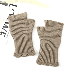 Detail of camel knit fingerless gloves with ruffle edge and vertical ribbed texture