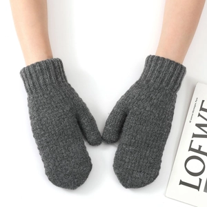 Detailed view of grey knit mittens featuring thick ribbed cuffs and warm wool texture