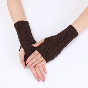 Detail of cable knit fingerless arm warmers in dark brown with textured thumb opening