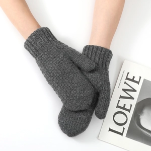 Detail of grey cable knit fingerless gloves with ribbed windproof cuffs for winter