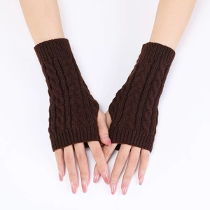 Detail of dark brown cable knit fingerless gloves showing texture and arm sleeve design