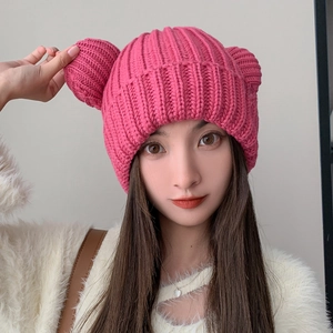 Cute pink knitted beanie with bear ears and thick ribbed texture for women's winter fashion