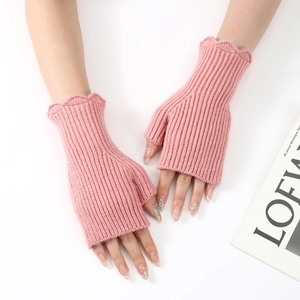 Detailed close-up of pink ribbed knit fingerless gloves with elegant wavy ruffled edges