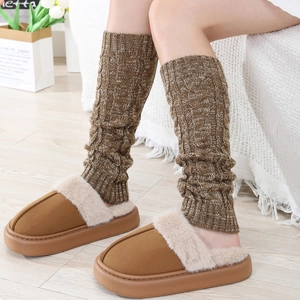 Thick cable knit leg warmers in coffee brown paired with cozy plush slippers for winter