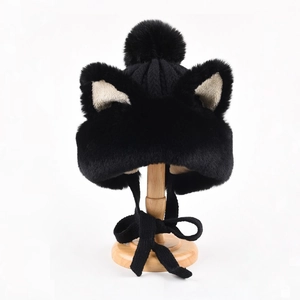 Detailed close-up of plush cat ear winter hat with pom-pom and cozy knitted ties