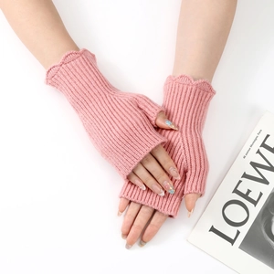 Detailed close-up of pink knit fingerless gloves featuring vertical stripes and ruffled cuffs
