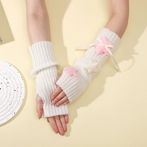 Detailed knit of white Y2K arm warmer with pink plush stars and ribbon bow detail